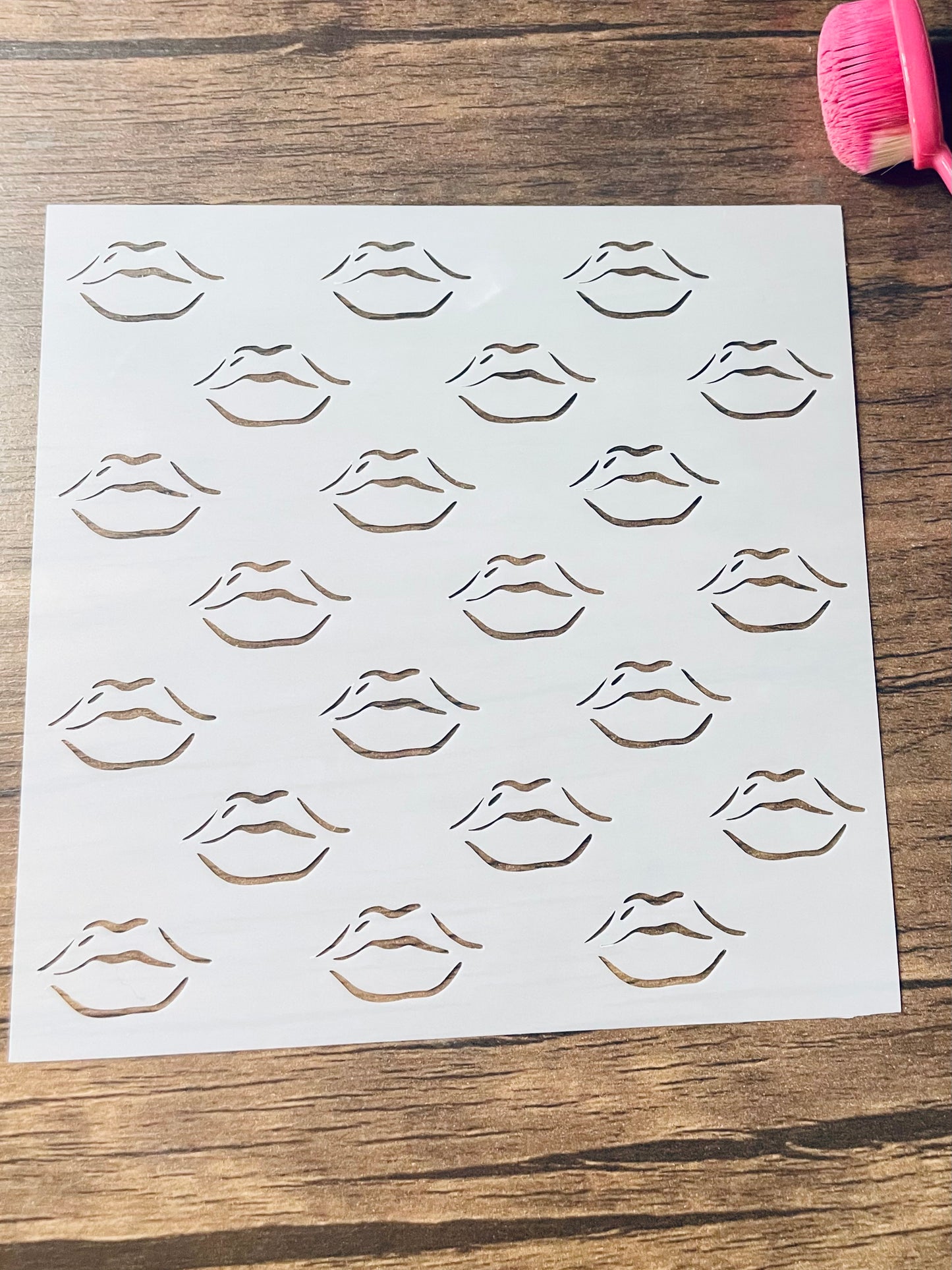 5.75” x 5.75” frosted stencil with Silhouettes of: The outlines of lips in a pattern