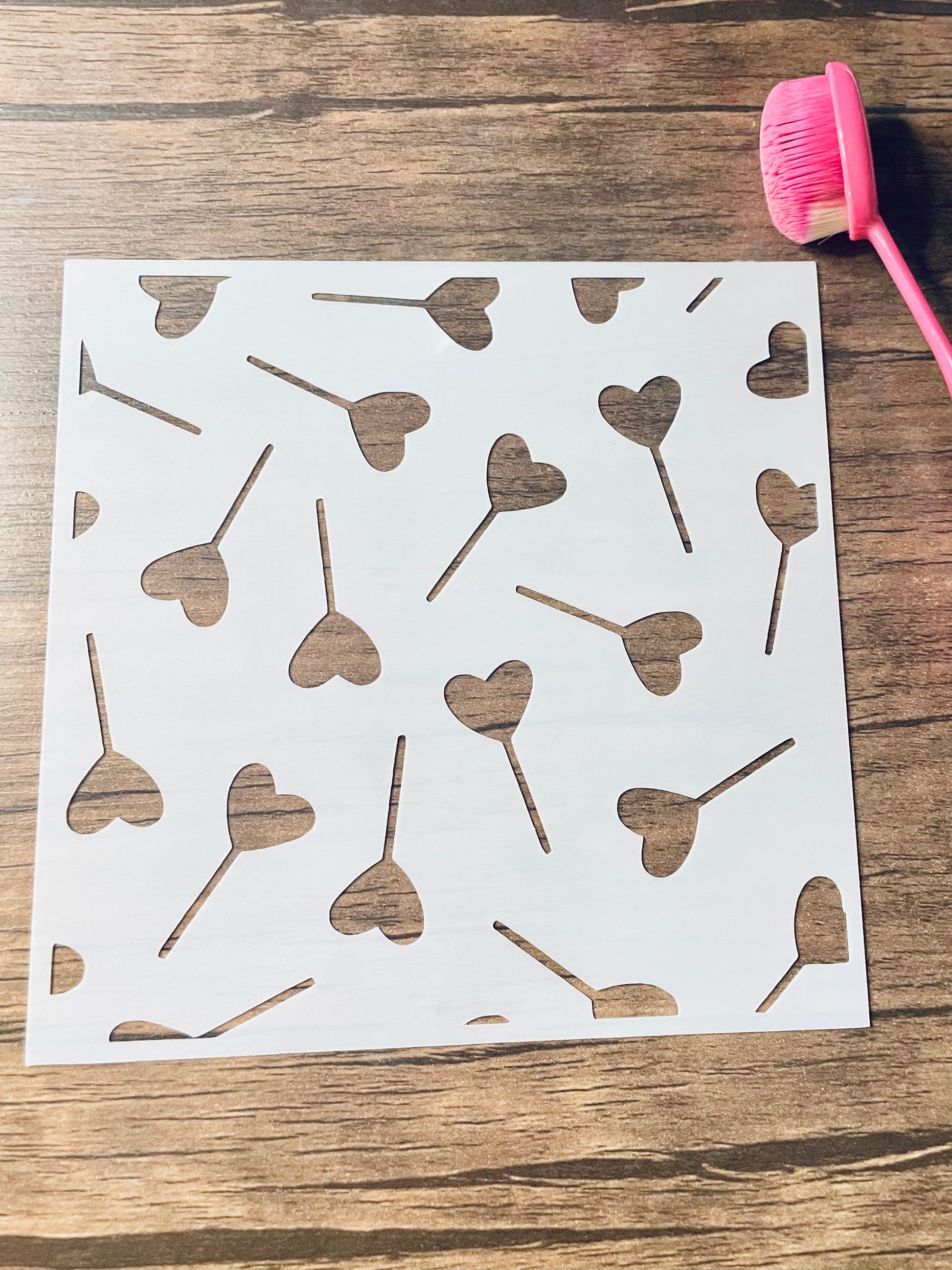 5.75” x 5.75” frosted stencil with Silhouettes of heart shaped suckers in a random pattern 