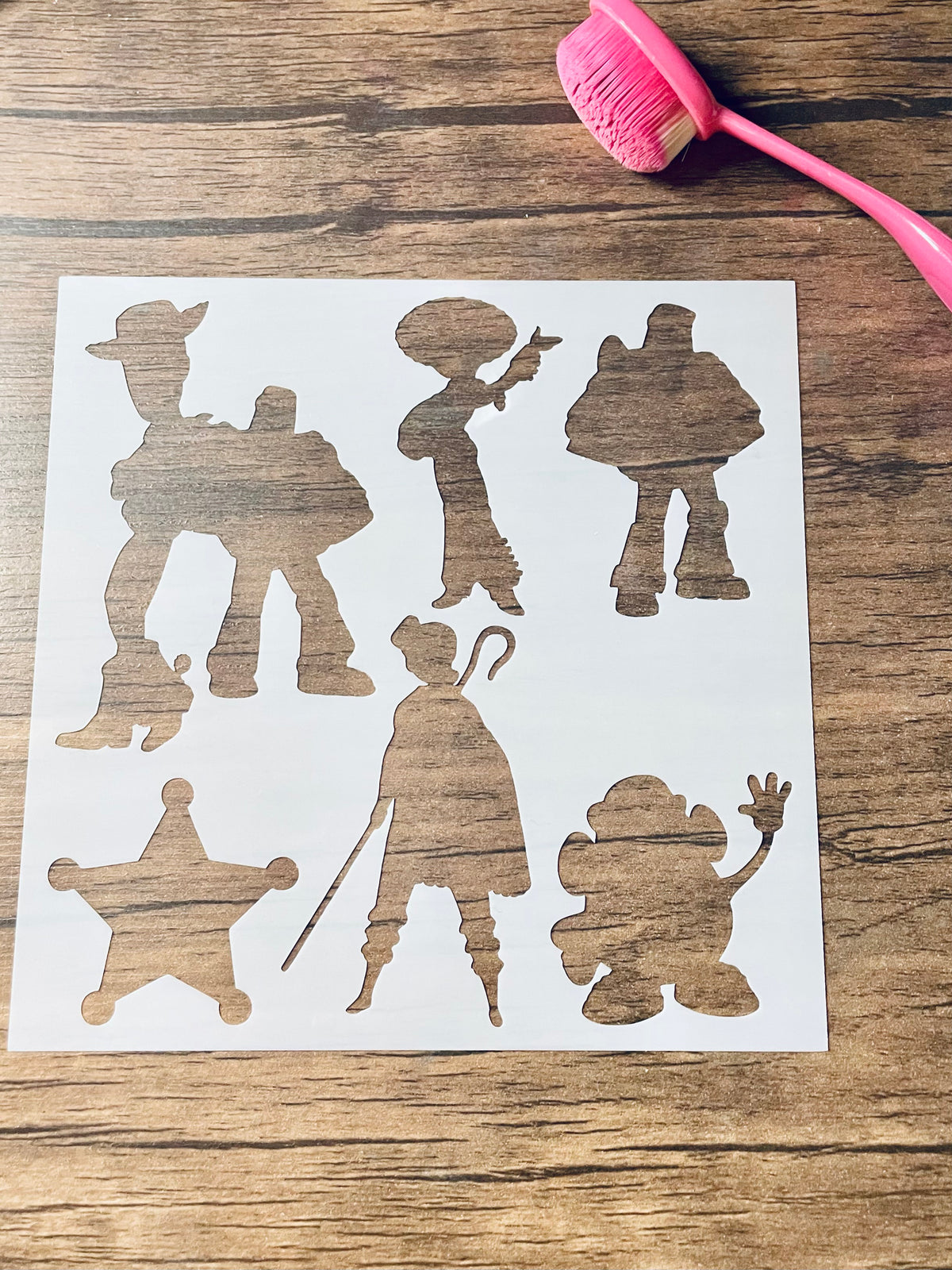 5.75” x 5.75” frosted stencil with Silhouettes of: a cowboy and space ranger, cowgirl, space ranger, cowboy badge, bo peep, and a potato head