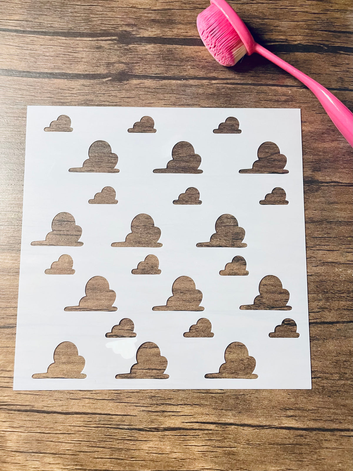 5.75” x 5.75” frosted stencil with Silhouettes of fluffy clouds in a pattern