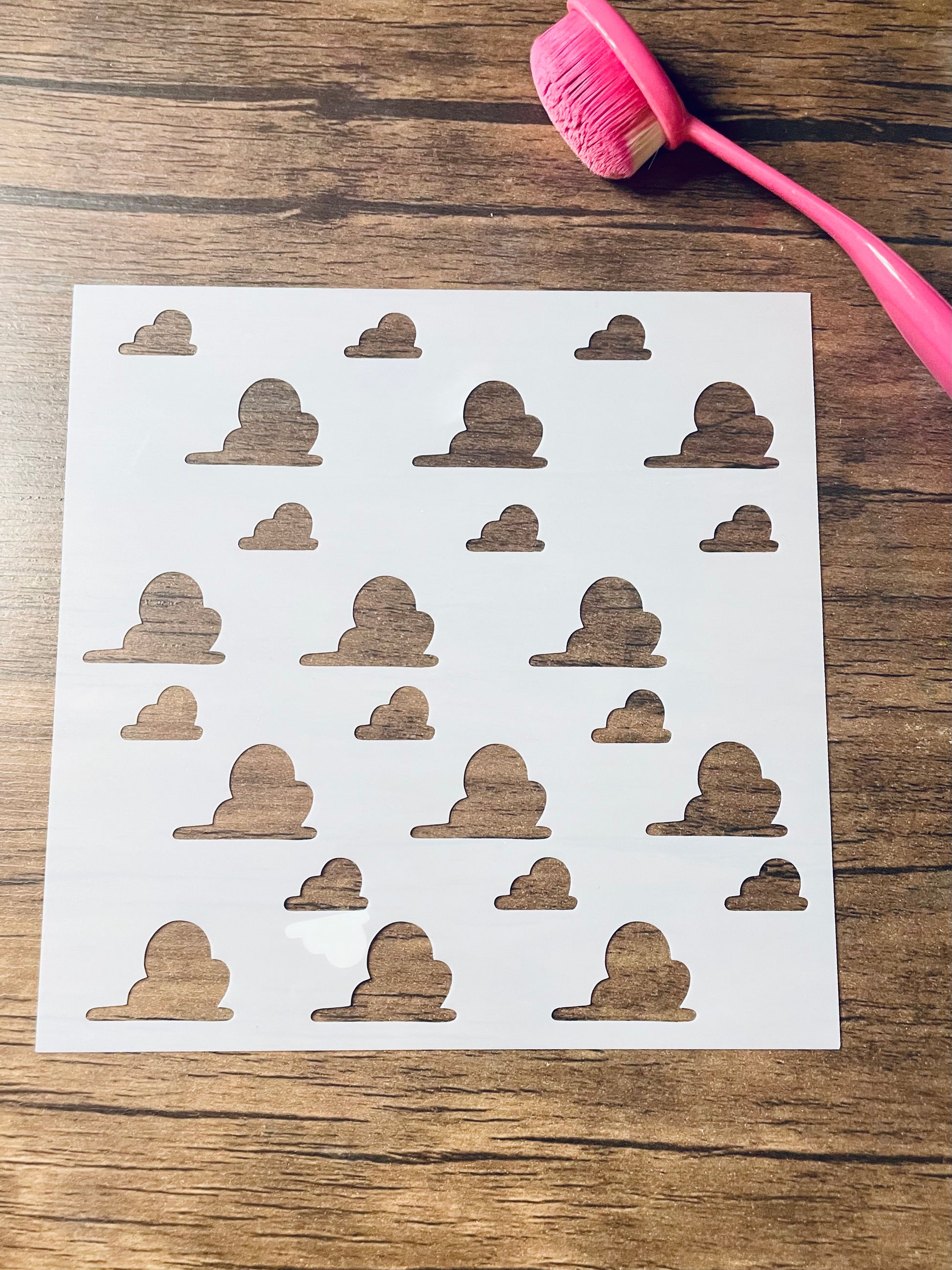 5.75” x 5.75” frosted stencil with Silhouettes of fluffy clouds in a pattern