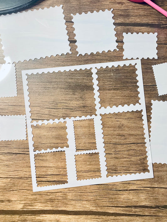 5.75” x 5.75” frosted stencil with Silhouettes of: 7 different stamp shaped cutouts.  The cutout pieces are on the edge of the stencil scattered around.  Stencil is on a wood surface with a pink brush 